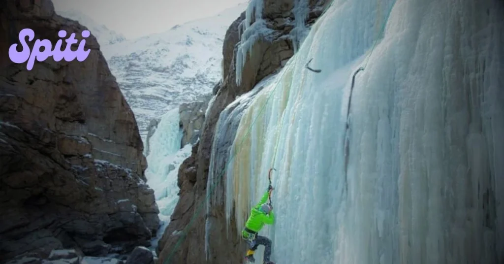 Climber on a vertical frozen waterfall in Spiti Valley